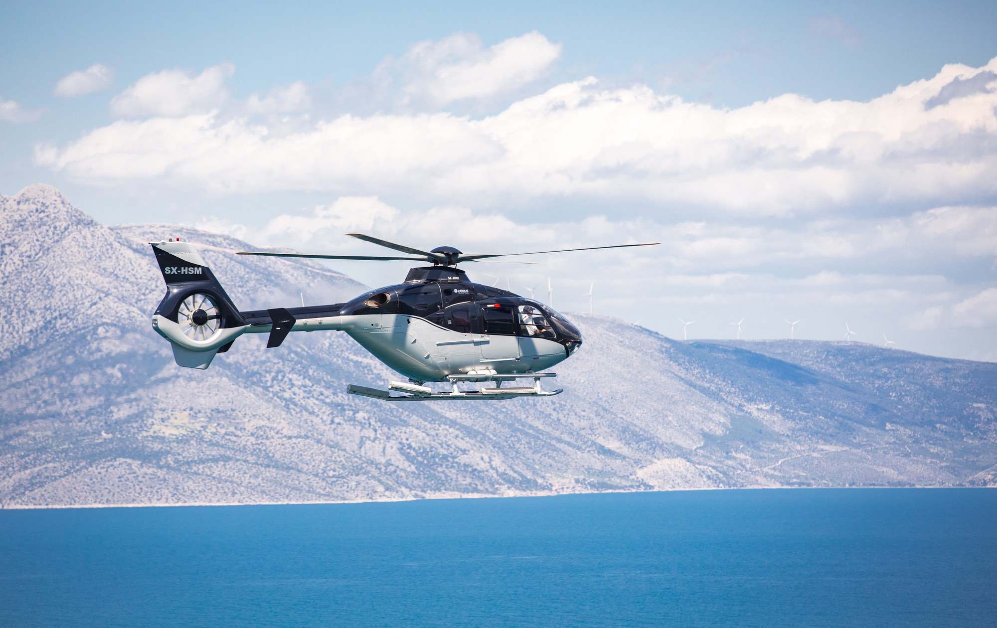 Private helicopter over the Greek coast